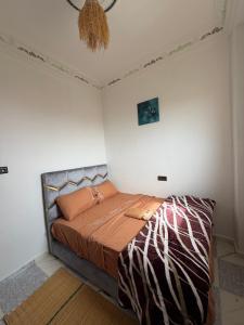 a bedroom with a bed in a white room at Gaia guest house in Taghazout