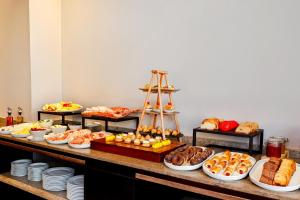a buffet with many different types of food on a table at NH Collection Bogota Hacienda Royal in Bogotá