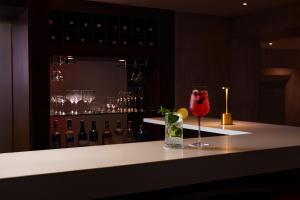 a bar with a wine glass sitting on a counter at NH Collection Bogota Hacienda Royal in Bogotá