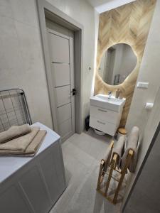 a bathroom with a sink and a mirror at Apartmány Baťovany in Partizánske +40 photos