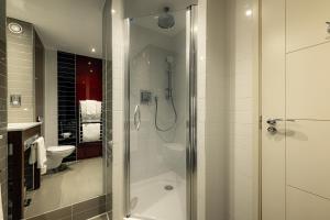 a bathroom with a shower and a toilet at Dakota Edinburgh in Queensferry