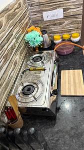 a stove top oven sitting on top of a counter at Varāya 1RK Studio in Vrindāvan