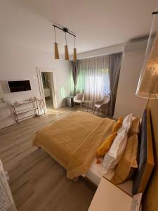 a bedroom with a large bed and a living room at Villa NIAN Boutique in Constanţa
