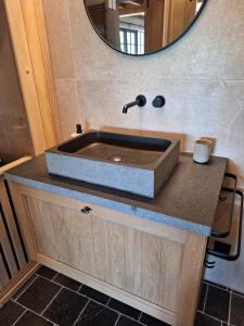 a bathroom with a sink and a mirror at Gezellig huisje met zwembad en sauna in Ellezelles - Bellezelles in Ellezelles +20 photos