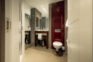 a bathroom with a toilet and a sink at Dakota Edinburgh in Queensferry