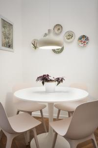a white table and chairs in a white room at La Casa sui Colli in Bologna