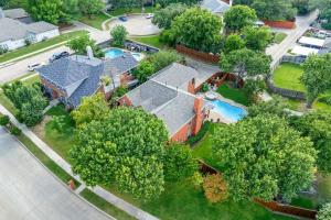 an aerial view of a house with a swimming pool at Meadow Park in Allen