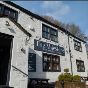 a building with a sign that reads the millstone inn dining at The Milestone in Sowerby Bridge