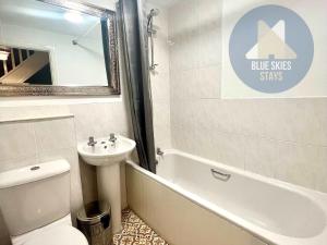 a bathroom with a sink and a toilet and a bath tub at Puffin House in Seaton Carew