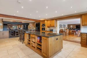 a large kitchen with wooden cabinets and a large island at Broadridge Manor in West Worlington