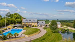 an aerial view of a large house with a swimming pool at Broadridge Manor in West Worlington