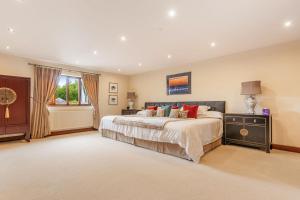 a large bedroom with a large bed and a window at Broadridge Manor in West Worlington +29 photos