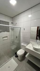 a bathroom with a toilet and a sink at Mimari Hotel in Tangara da Serra +44 photos