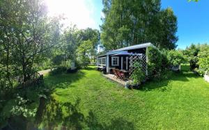 a small house in the middle of a yard at Björklunda, lakes, canoe, sauna in Näfstorp