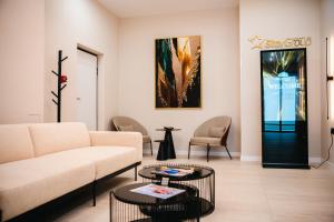 a living room with a couch and two tables at Stars Hotel in Jelah