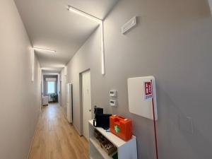 a room with a white wall with a refrigerator at Palazzo del Toro 2 in Montesilvano +50 photos