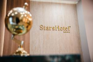a room with a star hotel sign on a wall at Stars Hotel in Jelah