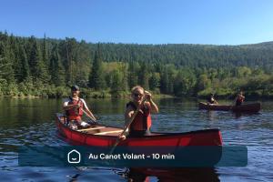 a group of people in canoes on a lake at Chalet Gratitude with Private SPA & Sauna in Saint Come