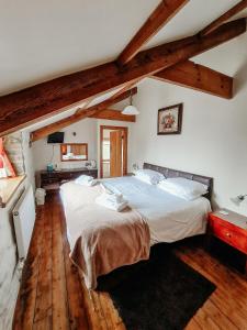 a bedroom with a large bed in a room with wooden floors at The Barn B&B in Margam