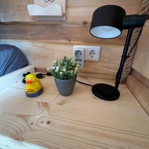 a desk with a lamp and a potted plant on a bed at Winzerhaus Gärtner - An der Loreley in Sankt Goar