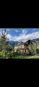 a large house in the middle of a field at Peace homestay n cafe in Kalgha
