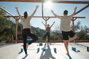 a group of people doing yoga on a roof at Casa del Bienestar in Lanjarón
