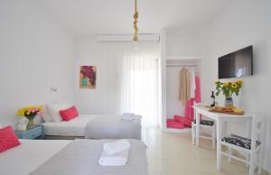 a white room with a bed and a table at Bella Terra Nature Living in Asprovalta