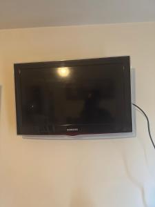 a flat screen tv hanging on a wall at The Bush Residence, Shepperton - Two Ground Floor Guest Bedrooms in Shepperton