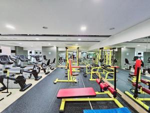 a gym with a lot of treadmills and machines at We -Ciel de Mer in Busan