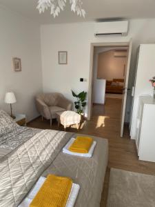 a bedroom with a bed and a living room at Angyalkert in Balatonszárszó