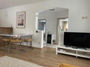 a living room with a table and a flat screen tv at Angyalkert in Balatonszárszó