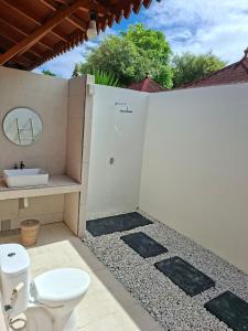 a bathroom with a toilet and a sink at Westwood Bungalow in Gili Trawangan +96 photos