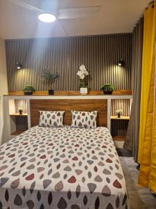 a bedroom with a large bed with two pillows at L'écrin des hauts in Saint-Denis