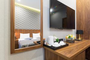 a hotel room with a bed and a mirror at Five Points Square - City Center in Belgrade
