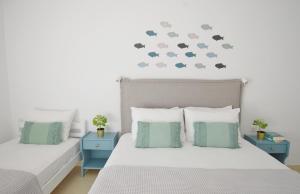 a bedroom with two beds and two blue night stands at Bella Terra Nature Living in Asprovalta