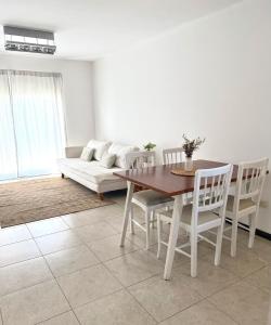 a living room with a table and chairs and a couch at R Haus 2 Con Cochera in Concordia +3 photos