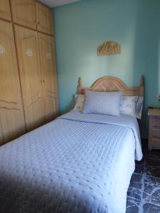 a bedroom with a large bed with a wooden headboard at Elche Holidays in Elche
