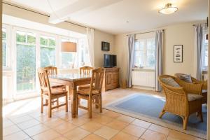 a dining room with a table and chairs at Ferienhaus Werder in Zingst in Zingst