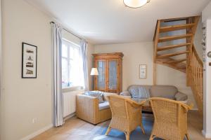 a living room with a couch and a table at Ferienhaus Werder in Zingst in Zingst