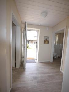 an empty hallway with a door open to a room at Ferienhaus Tutsch Westblick in Wangels