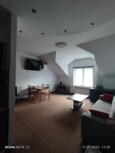 a living room with a couch and a table at APARTAMENT W CENTRUM OLESNA in Olesno