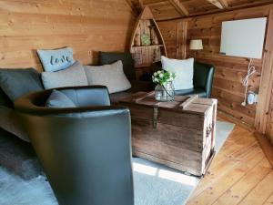 a living room with a couch and a table at Magic Kota - Sternenguckerhaus in Wilhelminenthal +1 photo