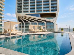 a swimming pool in front of a building at Mercury Suites Premium Apartments With Pool Access in St. Julianʼs