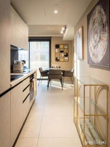 a kitchen and dining room with a dining table at Mercury Suites Premium Apartments With Pool Access in St. Julianʼs