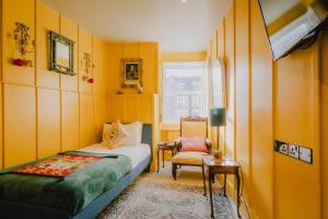 a bedroom with a bed and a chair and a window at The Galaxie in Oxford