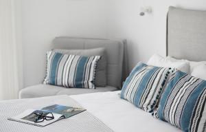 a bed with a book and a pair of glasses on it at Bella Terra Nature Living in Asprovalta