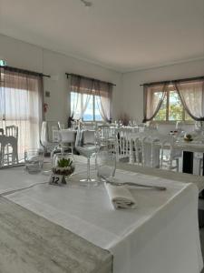 a dining room with a table with glasses and chairs at Hotel Panorama in Cerreto di Spoleto