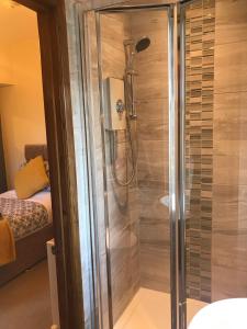 a shower with a glass door in a bathroom at Glendale Guest House in Penrith +100 photos