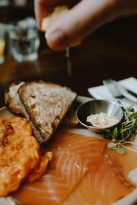a plate of food with fish and bread on a table at The Pilgrm in London