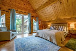 a bedroom with a bed and a couch and windows at 3 Bed in Wadebridge oc-p34722 in Little Petherick